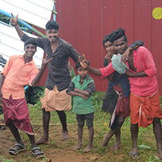 Men and children smiling in Kerala, India