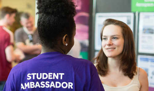 Woman at open day talking to Student Ambassador