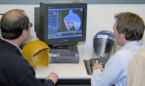 Student and tutor looking at police helmet design on computer screen