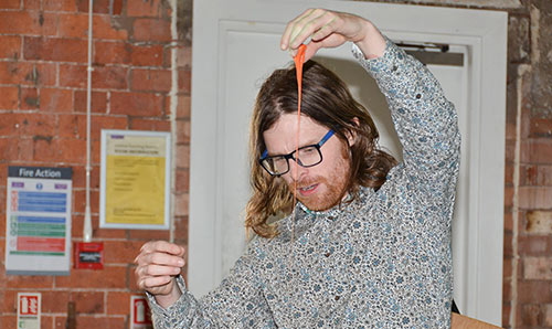 Teacher demonstrating a materials science experiment