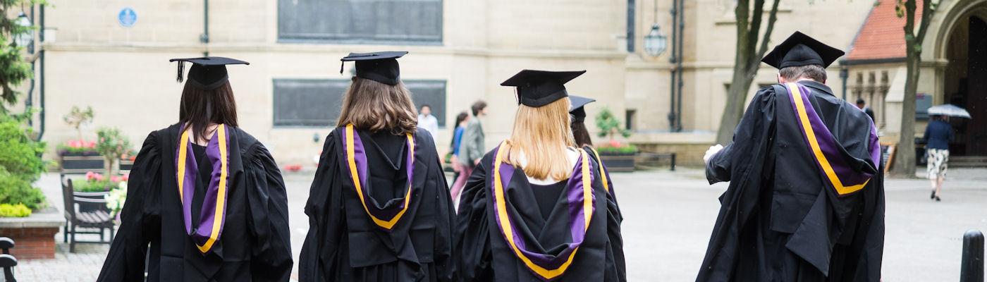 Students walking in their graduation gowns