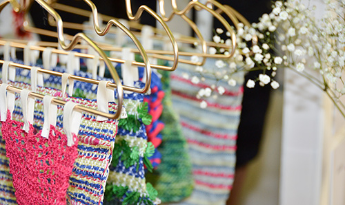 Garments on coat hangers in a row