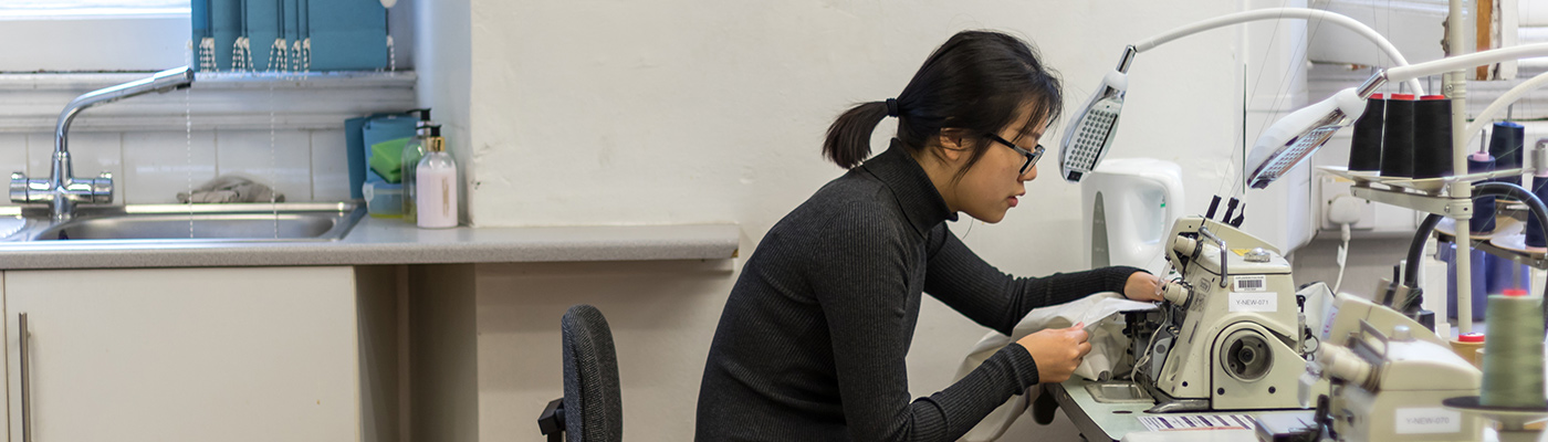 Female student operating a sewing machine