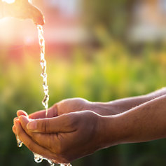 A hand under a water tap in India