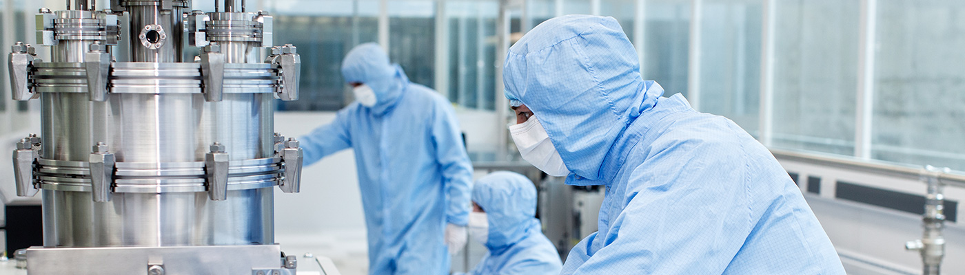 Three students conducting graphene experiments in lab