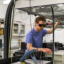 A researcher operating equipment in the PSI