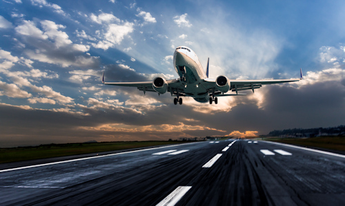 Passenger aeroplane landing at dusk