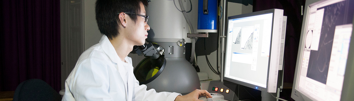 Student assessing microscopy results on computer