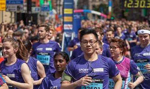 Section of purple wave - university staff and students in Manchester 10K