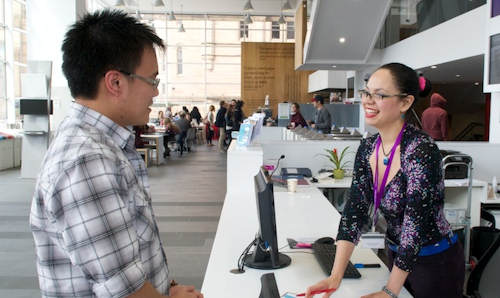 Male making an enquiry of female staff member