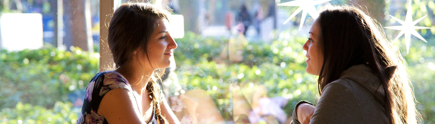 Two students chatting over coffee