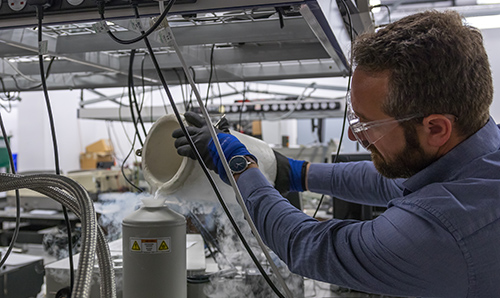 Researcher pouring liquid in the Photon Science Institute