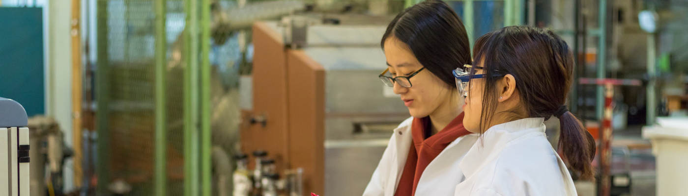 Two research students in white labcoats