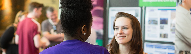 Prospective student speaking to current Manchester student at open day